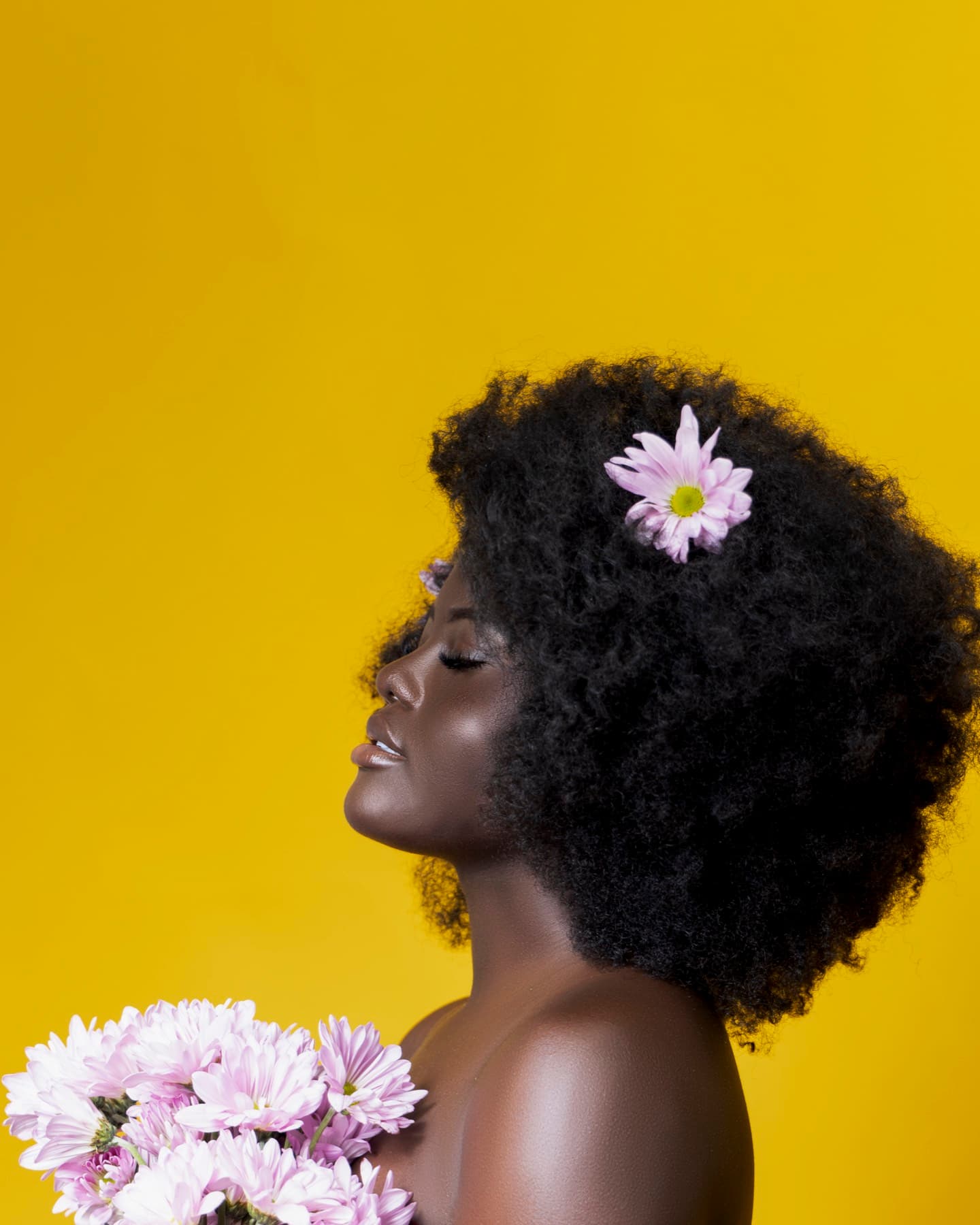 Beauty portrait with direct gaze and softly lit styling.